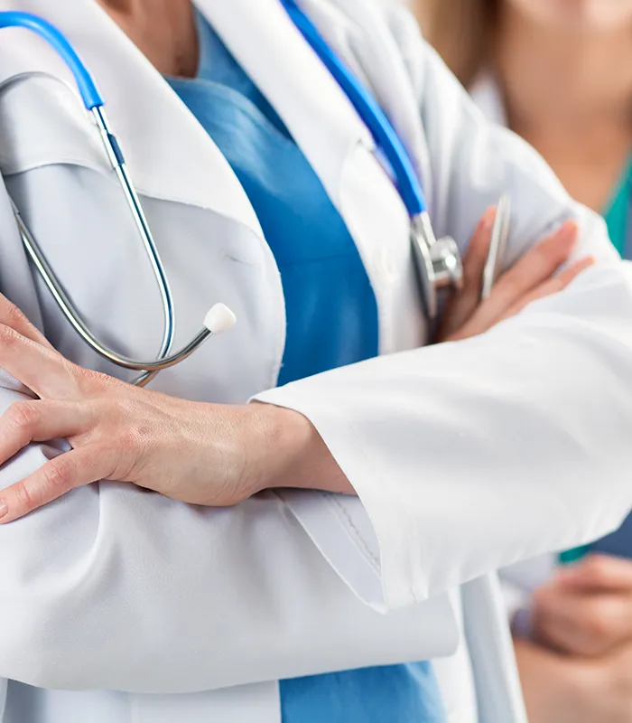 close-up-view-two-doctors-standing-with-their-arms-crossed-chest-ready-work