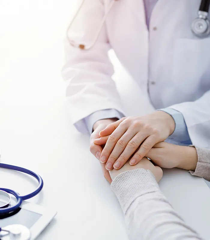 doctor-patient-sitting-table-clinic-office-focus-is-female-physician-s-hands-reassuring-woman-only-hands-close-up-medicine-concept