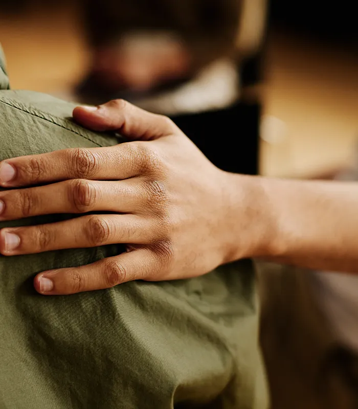 hand-young-supportive-man-consoling-his-friend-with-post-traumatic-syndrome