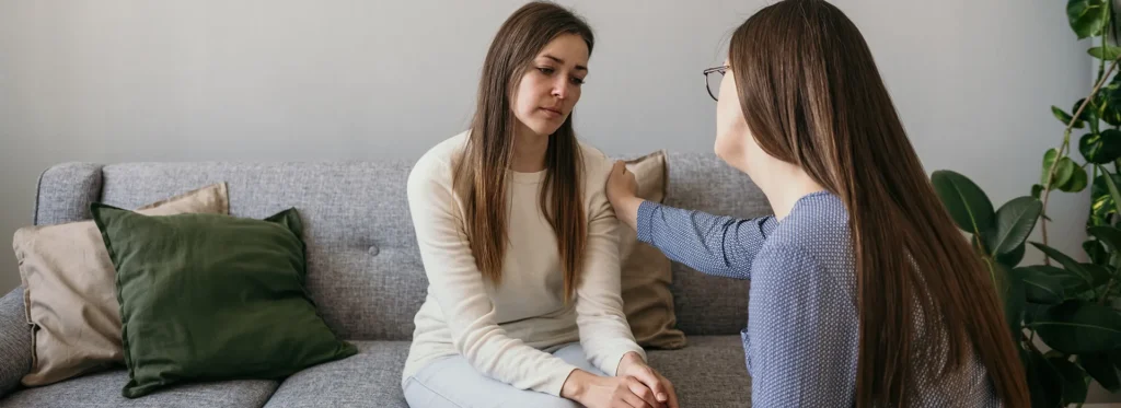psychologist-woman-put-her-hand-shoulder-upset-woman-patient-gesture-support-psychological-assistance-woman