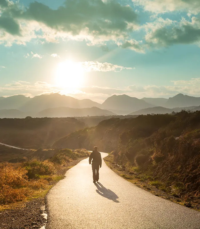 scenic-road-mountains-travel-background-man-going-sunrise-background