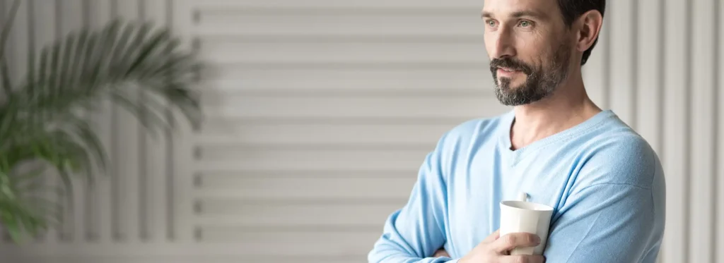 with-cup-tea-handsome-happy-relaxed-man-crossing-his-arms-holding-tea-cup-while-having-rest